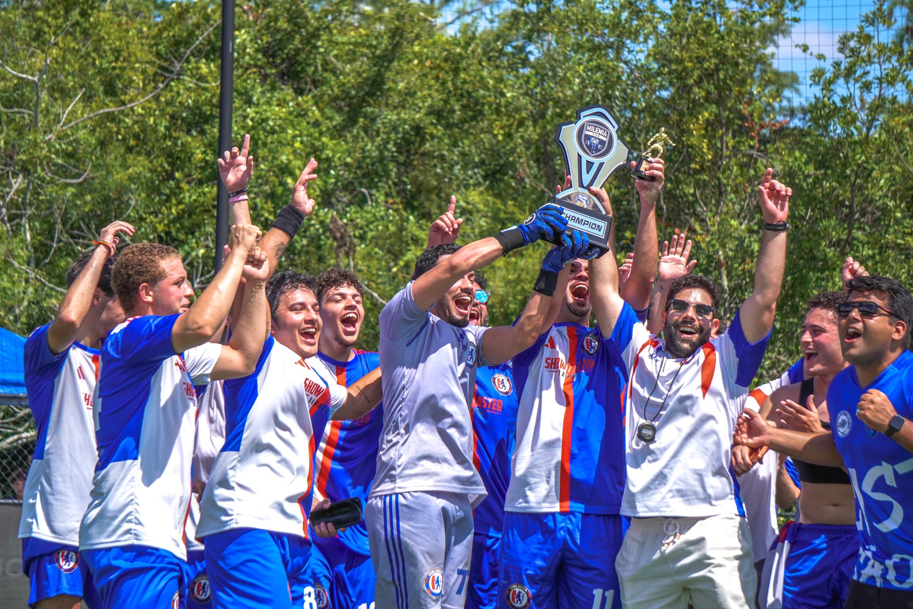 Chelsicha FC players lifting the Milenia Cup trophy